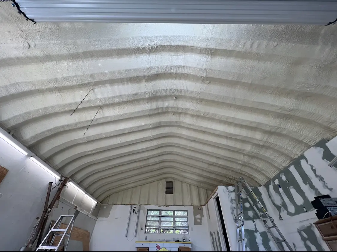 Spray polyurethane foam applied to the underside of a metal roof deck in Lennox